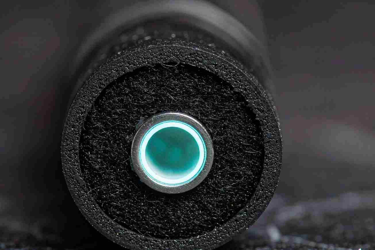 A cross-section of a heavy black undersea cable with a glowing cyan core