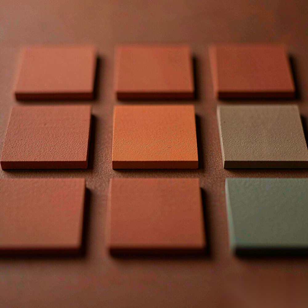 A precise three-by-three grid of matte colour chips, one chip the wrong colour