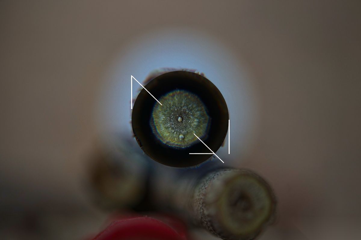 A blurred abstract scene with one small region sharply in focus, ringed by glowing brackets