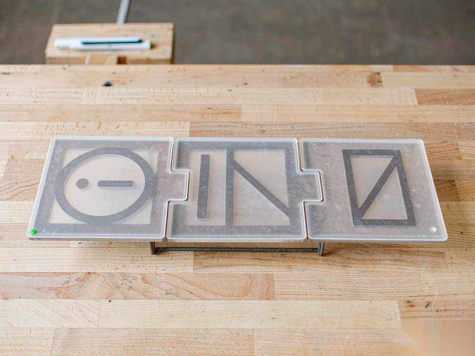 Three translucent information cards interlocking like puzzle pieces into a single straight line on a clean wooden workbench, representing search, reading, and writing merged into one path