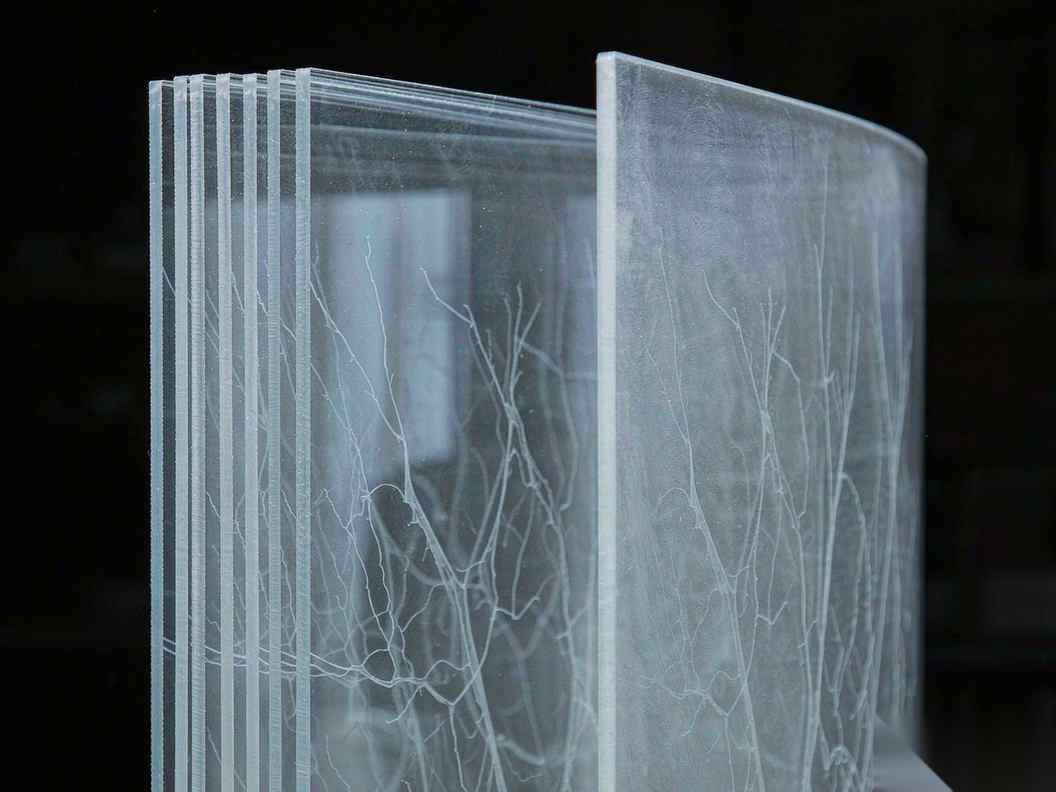 A branching tree of glowing lines on a dark surface multiplying far faster than the single hand at its base can touch, with most branches left unmarked, suggesting code volume outrunning human review